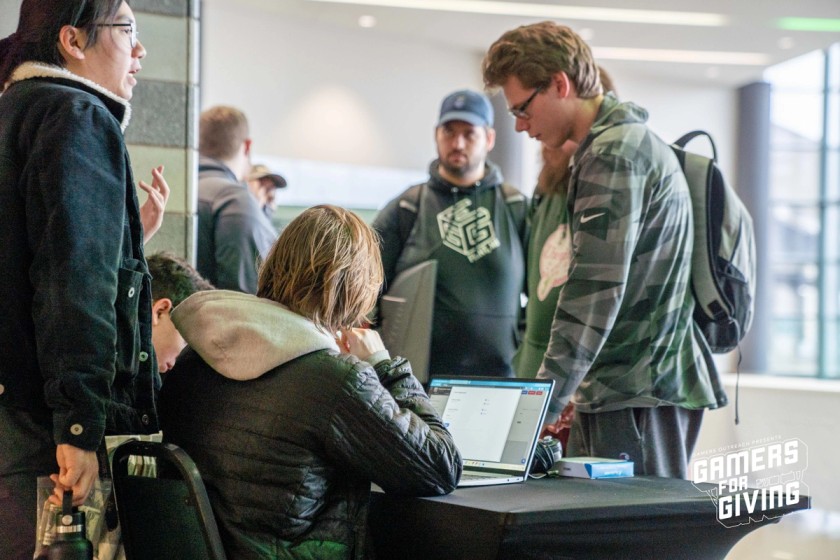 Person checking in to Gamers for Giving at the registration desk.